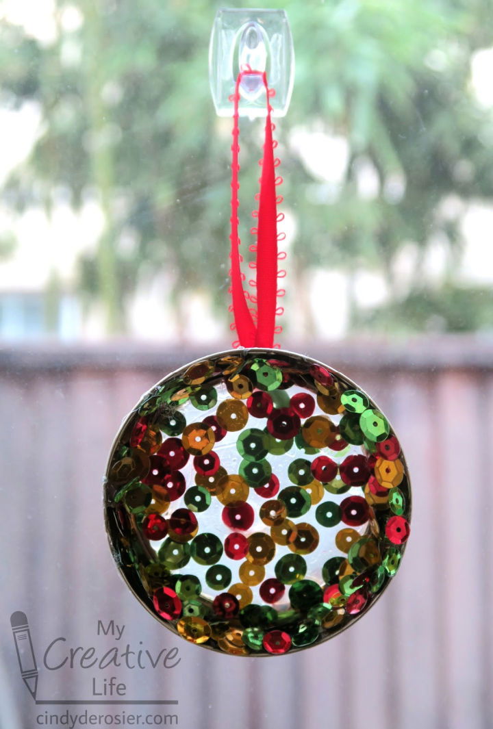 https://media.ialwayspickthethimble.com/wp-content/uploads/2023/03/Make-Your-Own-Hot-Glue-Sequin-Suncatcher.jpg